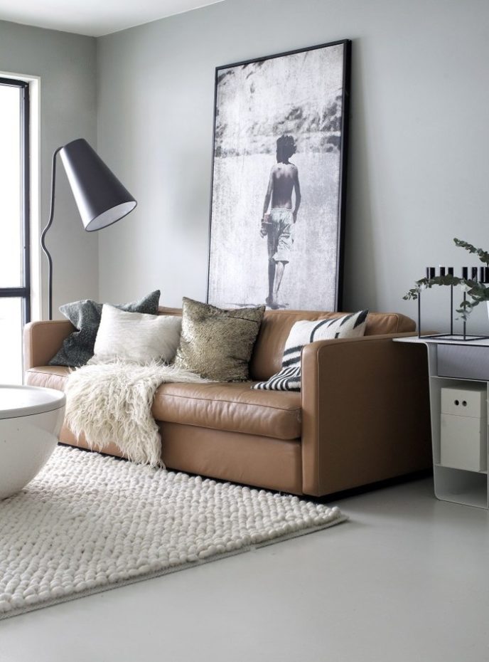 Post_tan leather sofa with oversized photograph and white rug.jpg