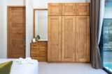 Spacious modern bedroom with wooden wardrobe.jpg