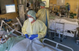 Intensive care nurses treat patients severely ill with Covid-19 disease in the Corona intensive care unit at the University Hospital in Halle/Saale on Monday, Nov. 22, 2021. The German air force Luftwaffe will begin assisting the transfer of intensive care patients from hospitals in Bavaria to northern German states.