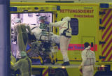 Rescue workers carry Coronavirus patients from Bavaria region to emergency vehicles in a hangar at the Helmut Schmidt Airport, in Hamburg, Germany, Sunday, Nov. 28, 2021. Germany has been fighting to curb the country’s worsening coronavirus situation, which is seeing increasing daily confirmed cases and is putting hospitals under severe strain. ()