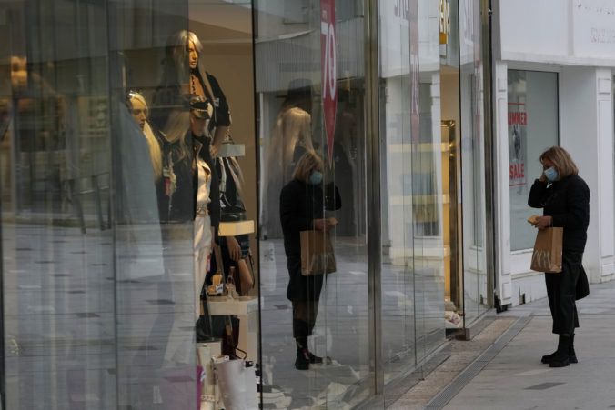 Virus Outbreak Cyprus A woman wearing a protective mask looks the shop case outside of a shop at a main shopping street in central capital Nicosia, Cyprus, Wednesday, Jan. 19, 2022. Tourism reliant Cyprus will lift a requirement for all inbound travelers to either show a negative COVID 19 test or to self isolate or quarantine themselves as of Mar. 1 as long as they have a valid vaccination certificate.