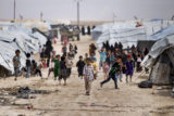 Children gather outside their tents, at al-Hol camp, which houses families of members of the Islamic State group, in Hasakeh province, Syria, May 1, 2021. Belgium judicial authorities said on Tuesday, June 21, 2022 they have repatriated 16 children and six mothers of Belgian citizenship who were held in Syria for their suspected connection with the Islamic State group.